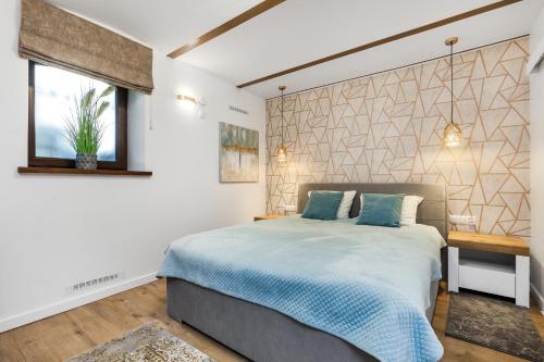 a bedroom with a large bed and a window at Apartamenty4you - Apartamenty Atlantic in Sopot