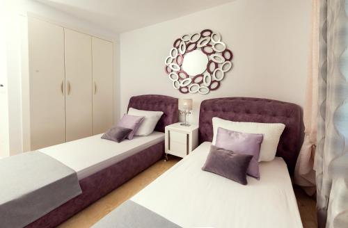 a bedroom with two beds and a mirror at Holiday VILLA GOLF & SEE VIEW Villamartin in Orihuela Costa