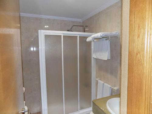 a bathroom with a shower and a sink at Hostal Los Palancares in Fuentes