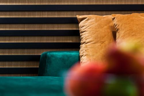 a close up of a green couch with a pillow at Apartamenty4you - Apartamenty Atlantic in Sopot