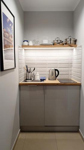 a kitchen with a counter with a tea kettle on it at Willa Abrazja - wypoczynek dla dorosłych in Jastrzębia Góra