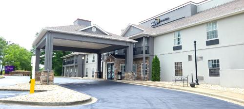 a large white building with a parking garage at Sleep Inn & Suites in Birmingham