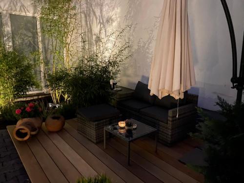 a patio with a couch and an umbrella and a table at Altstadt-Chalet @Conny's in Brilon