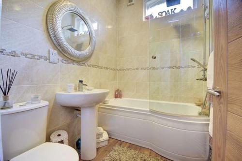 a bathroom with a sink and a toilet and a tub at Bunny Burrow in Whitby