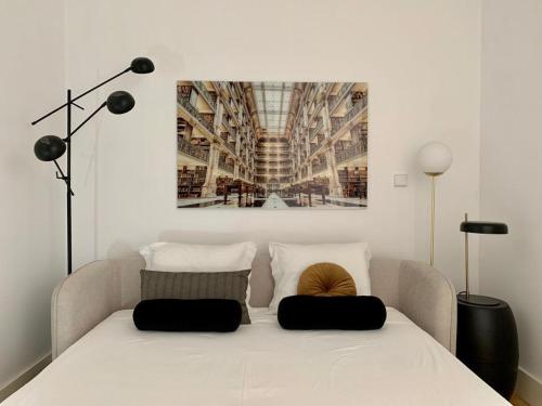 a bedroom with a white bed with two pillows on it at Oporto Chic&Cozy - São Bento da Vitória in Porto
