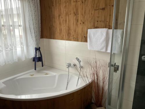 a bath tub in a bathroom with a shower at Szilvias Ferienwohnung in Tittling