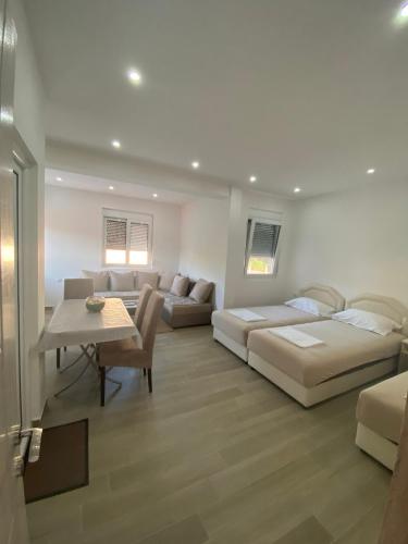 a living room with two beds and a couch at Gjoni Apartments in Ulcinj