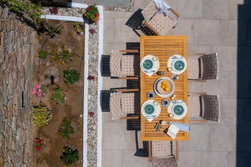 an overhead view of an outdoor table with chairs and tablesktop at The Be House in Sifnos