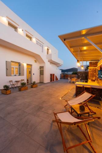 an outdoor patio with chairs and tables in a building at The Be House in Sifnos