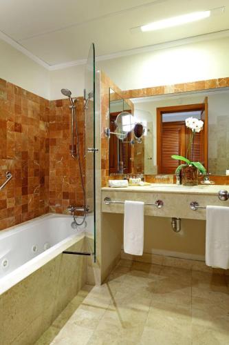 a bathroom with a tub and a sink and a shower at Grand Palladium Colonial Resort & Spa - All Inclusive in Akumal