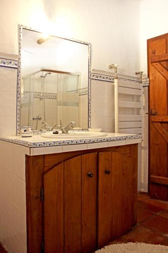 a bathroom with a sink and a mirror at Monte Pinheiro in Rabaços