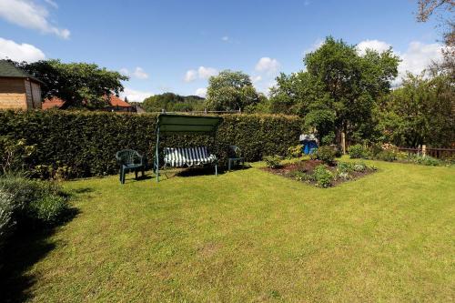 a garden with a bench in the grass at Pension Jana in Český Krumlov
