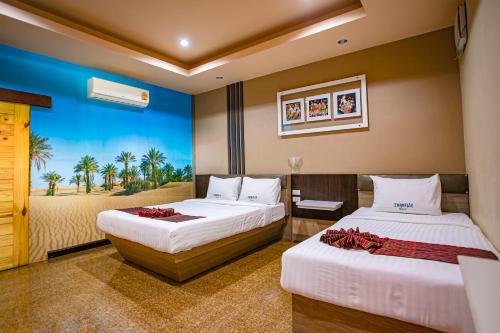 a hotel room with two beds and a window at Thansila Resort&Garden Buriram in Buriram