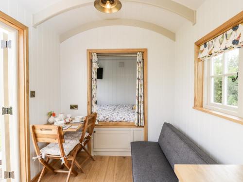 a dining room with a table and a bed in a room at Waylands in Faringdon