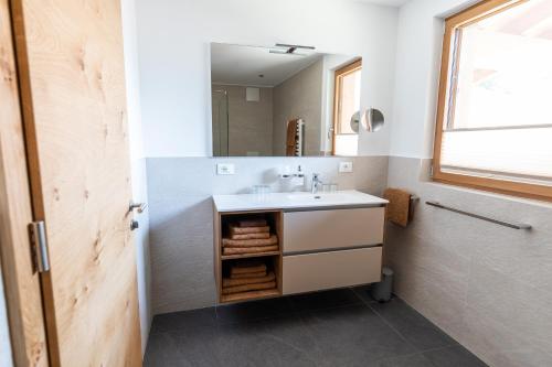 a bathroom with a sink and a mirror at Innermoarhof in Rifiano