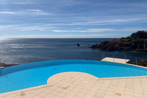 a swimming pool with a view of the ocean at Cap Neree Petit coin de paradis pieds dans l eau in Saint-Raphaël