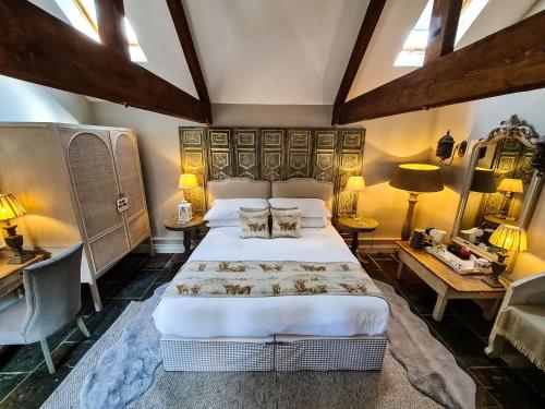 a bedroom with a large bed and two tables at Grantham Arms in Boroughbridge