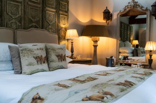 a bedroom with a large bed with pillows on it at Grantham Arms in Boroughbridge