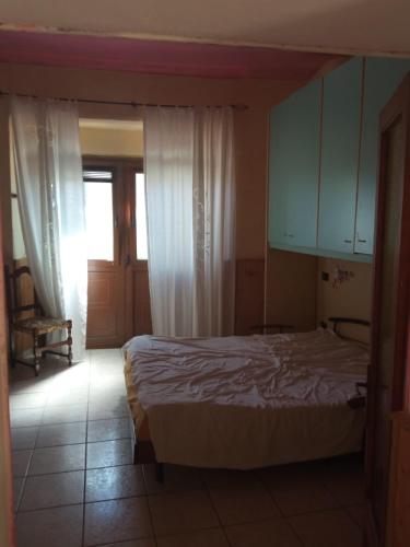 a bedroom with a bed and a window and a door at Casa Garage in Roccatederighi