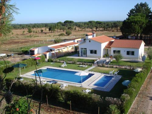 an aerial view of a house with a swimming pool at Quinta da Fonte de Grandola in Grândola