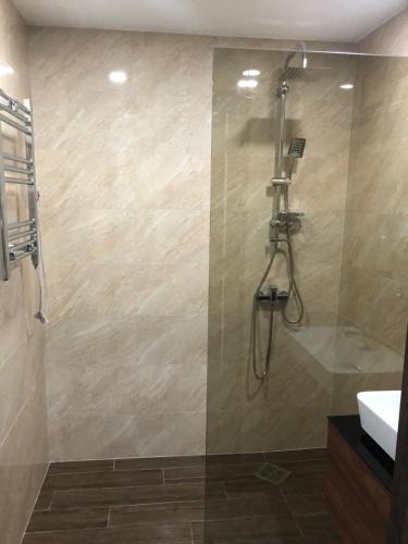 a bathroom with a shower and a sink at panorama beach tower in Batumi