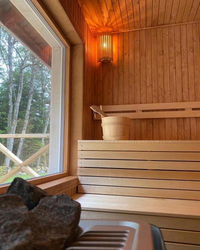a sauna with a window in a wooden cabin at Almas gård in Ullared