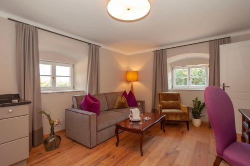 a living room with a couch and a table at Landhotel Wachau - Hotel Garni in Emmersdorf an der Donau