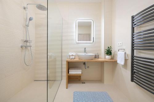 a bathroom with a sink and a shower at Villa Maxima with heated pool - Makarska Veliko Brdo in Makarska
