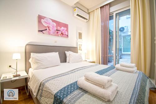 A bed or beds in a room at Syntagma Square Athenian apartments