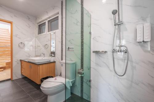 a bathroom with a toilet and a sink and a shower at Gala Pavilion Villa in Pattaya South