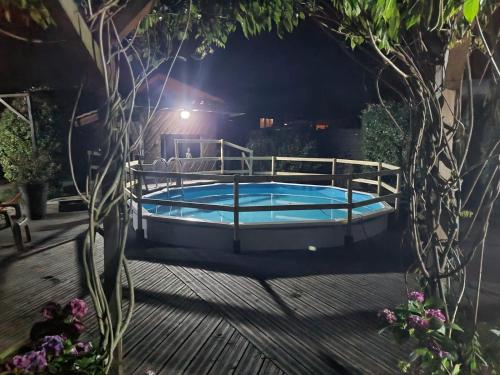 a swimming pool in a backyard at night at LA LANDAISE in Sainte-Eulalie-en-Born