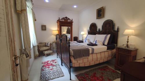 a bedroom with a large bed and a mirror at Natura e Arte in Pavullo nel Frignano