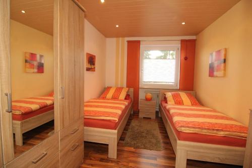een slaapkamer met 2 bedden en een raam bij Ferienwohnung Achatz in Bad Koetzting