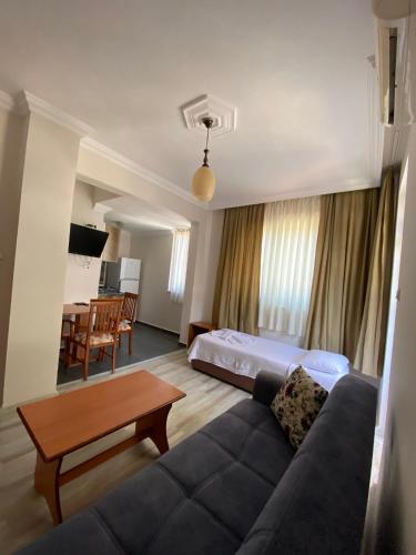 a living room with a couch and a table at Sempati Apart Hotel in Alanya