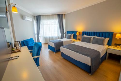 a hotel room with two beds and a couch at Armas Bella Sun in Side
