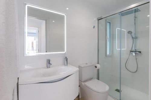 a bathroom with a toilet and a sink and a shower at MEVAMAR in Fornells