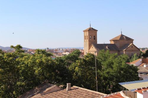 a building with a clock tower in a city at Apartamento Vistas molineras in Consuegra