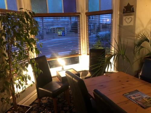 a dining room with a table and a large window at North Sands Lodge in Scarborough