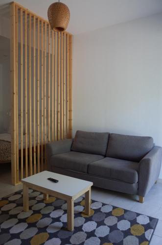a living room with a couch and a coffee table at Draugų namai in Druskininkai