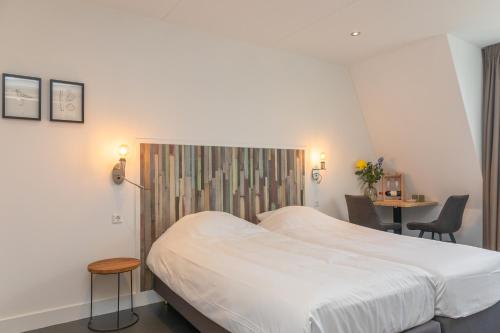 Een bed of bedden in een kamer bij Nieuw Leven Texel