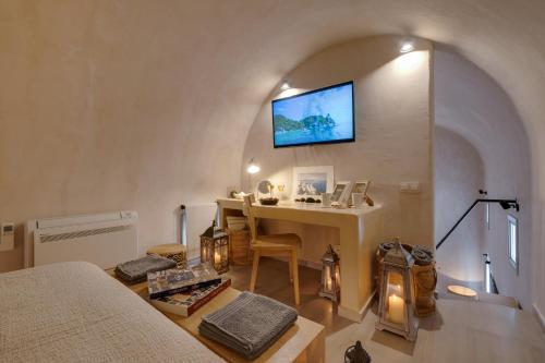 a room with a table and a tv on the wall at Villa Anemeli in Vóthon