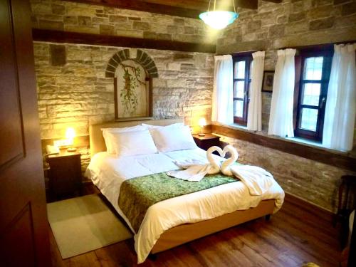 a bedroom with a bed with a towel on it at Gioraldi Art Hotel in Ano Pedina