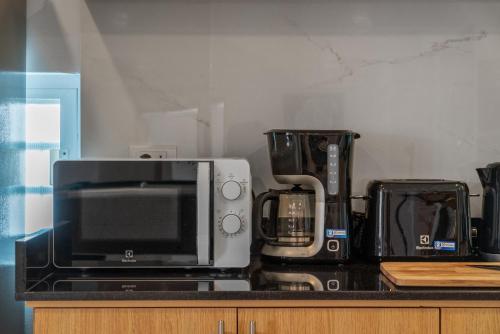 a kitchen counter with a microwave and a toaster oven at Gala Pavilion Villa in Pattaya South