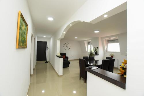 a living room with chairs and a dining room at Apartmani Pakalovic in Davidovac