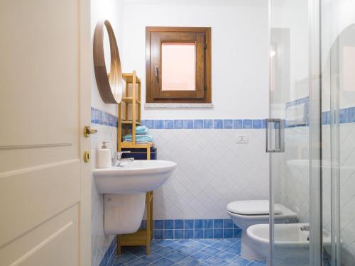 a bathroom with a sink and a toilet and a mirror at Myrsine 7D - Klodge in Murta Maria