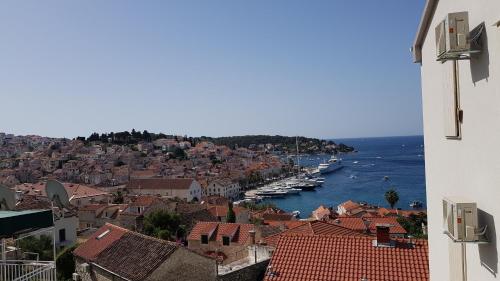 a view of a city with boats in the water at Apartments Boćin Rosso in Hvar