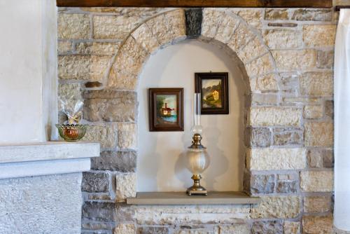 a niche in a stone wall with a lamp at Gioraldi Art Hotel in Ano Pedina