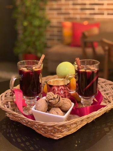 a basket with two cups of tea and some food at Foleza - Bed and breakfast in Vlorë