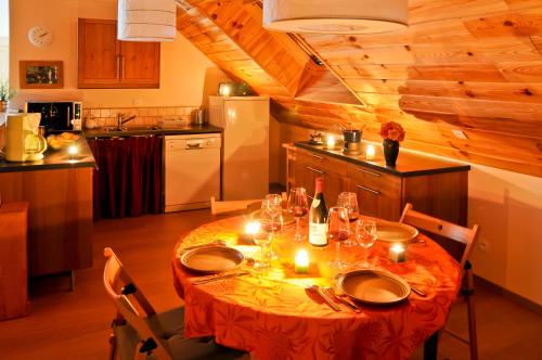 a kitchen with a table with candles on it at La cabane du bonheur, un gite écologique in Cornillon-en-Trièves