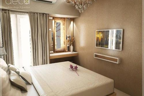 A bed or beds in a room at Cosmy Orchard Apartment at Pakuwon Mall with Wifi